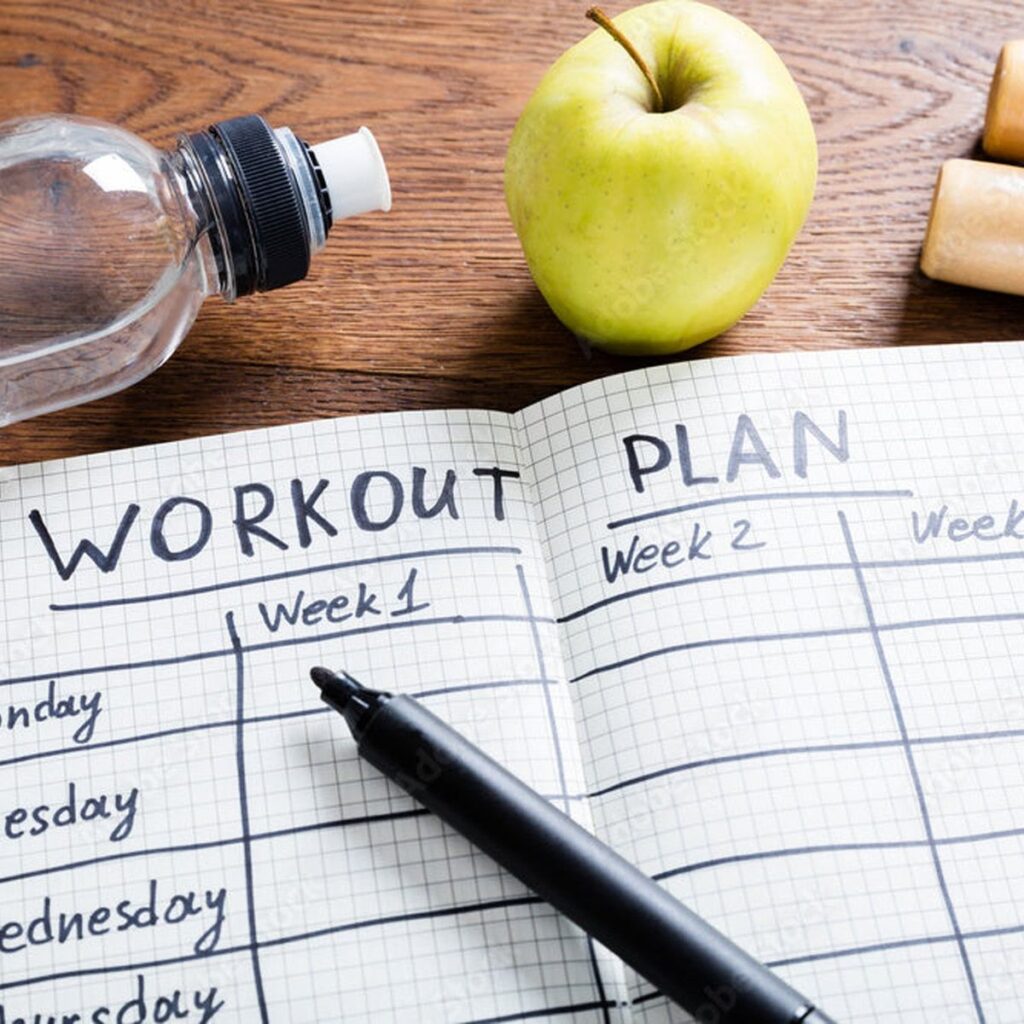 Personal fitness trainer workout plan notebook with healthy nutrition essentials